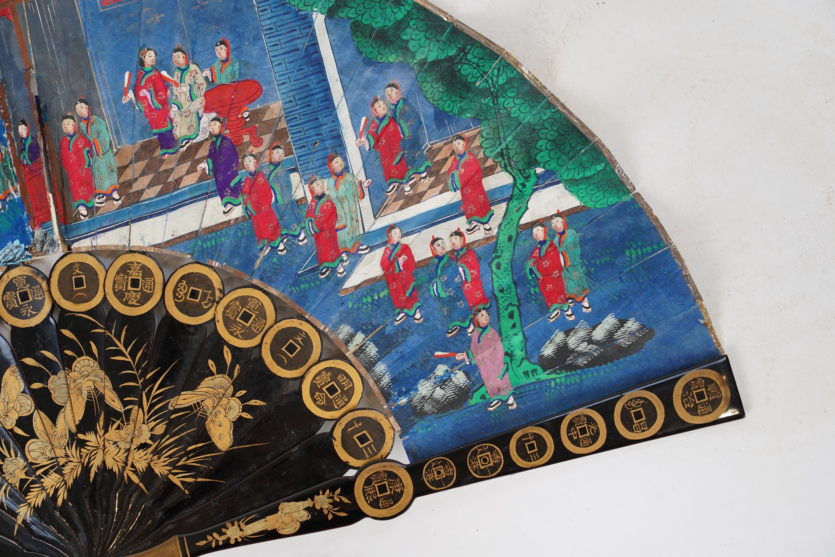 Three Chinese gilt-decorated black lacquer and painted leaf fans, 19th century